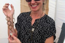 Catenya McHenry captures a photo of Alabama vintage jewelry designer Sara Hart holding a recycled necklace.