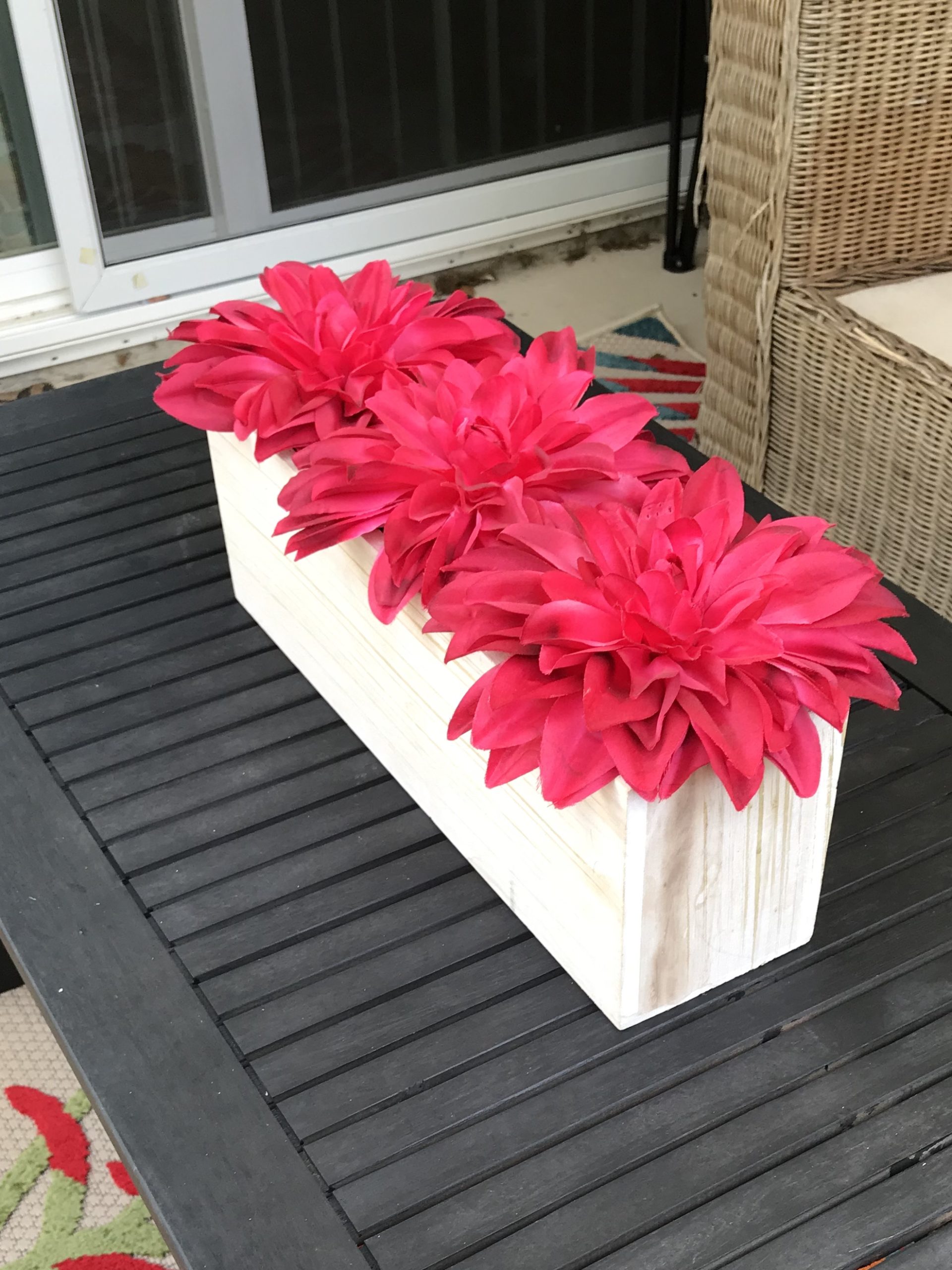 ReStylist Catenya McHenry creates an outdoor space by adding a floral centerpiece from Home Goods