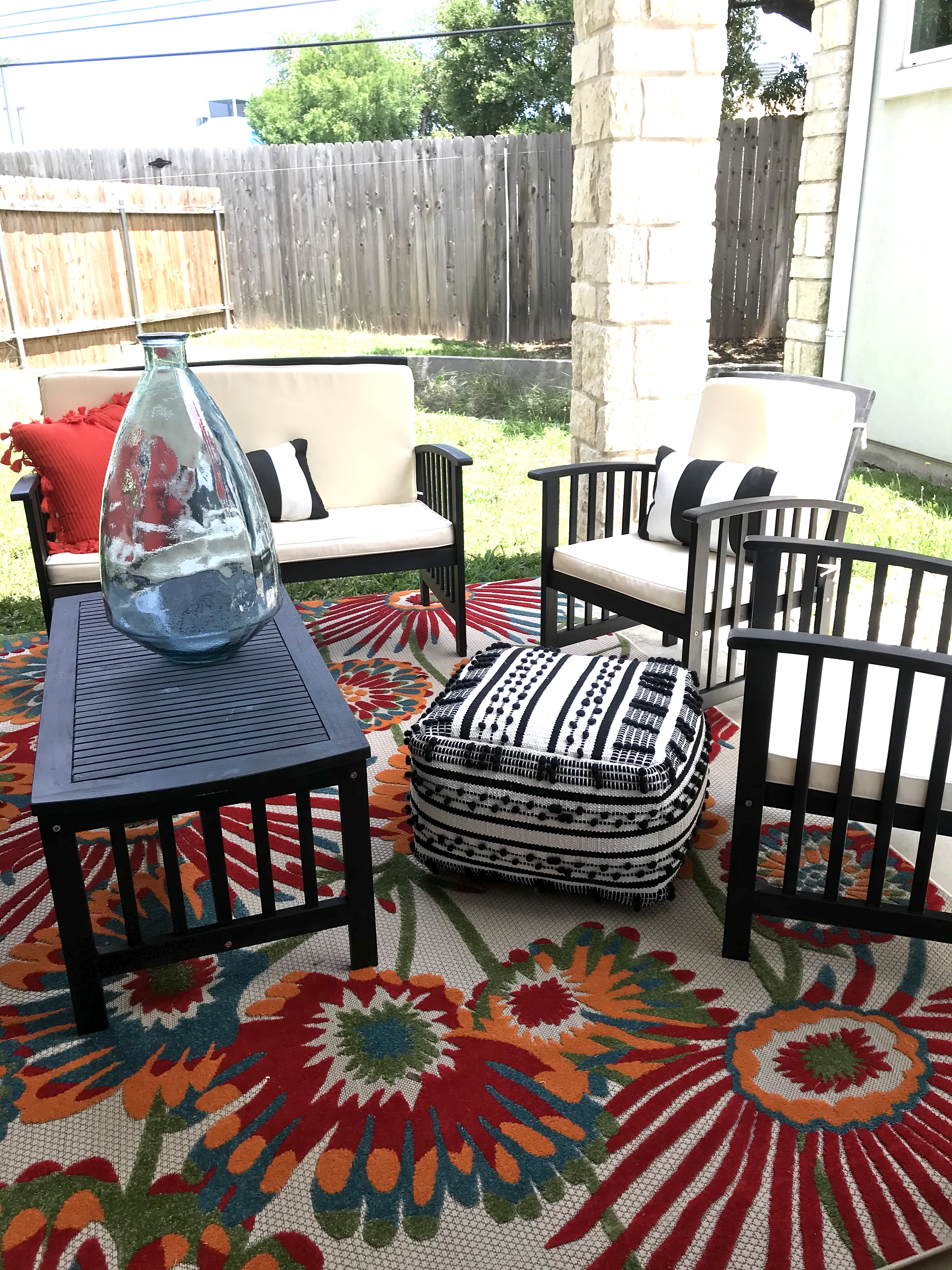 ReStylist Catenya McHenry creates an outdoor space by adding a tall hand blown turquoise vase from Home Goods