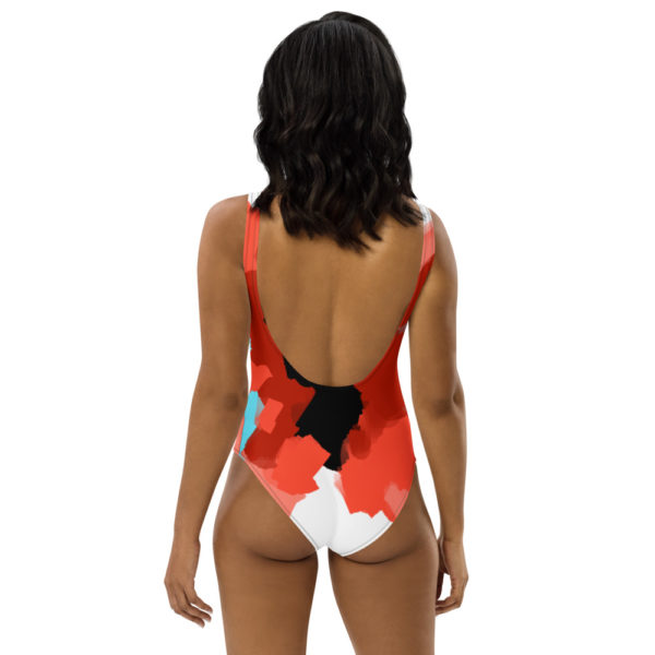 Black woman wears a custom Fuck Fear podcast butterfly one-piece swimsuit