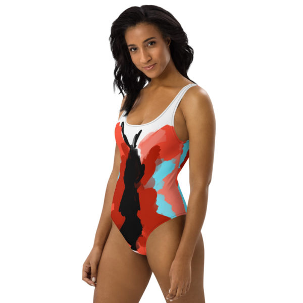 Black woman wears a custom Fuck Fear podcast butterfly one-piece swimsuit